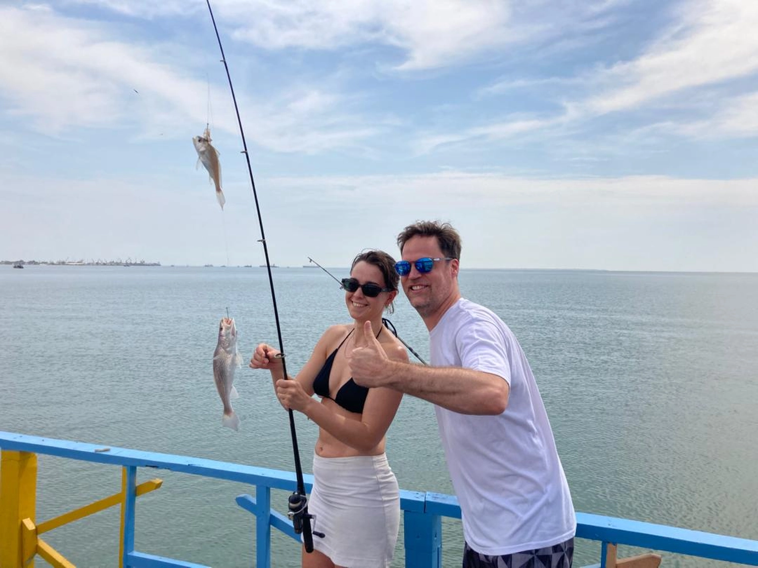 Gambia​ View Tours - Tourism services - A man and a woman caughting fish on River Gambia & Lazy Day Cruise